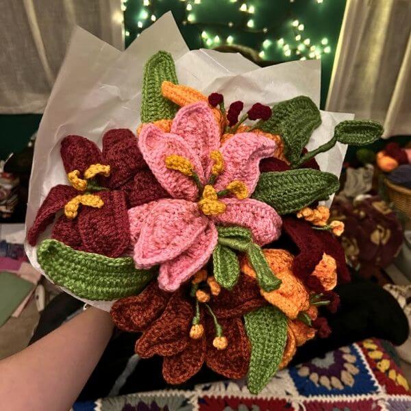 A photo of a knitted flower bouquet artwork by a one river educator