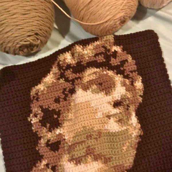 A photo of a crocheted statue of david artwork by a one river educator